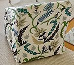 Chair with floral patterned fabric in white, green, and black.