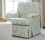 Armchair with light blue and white patterned slipcover.