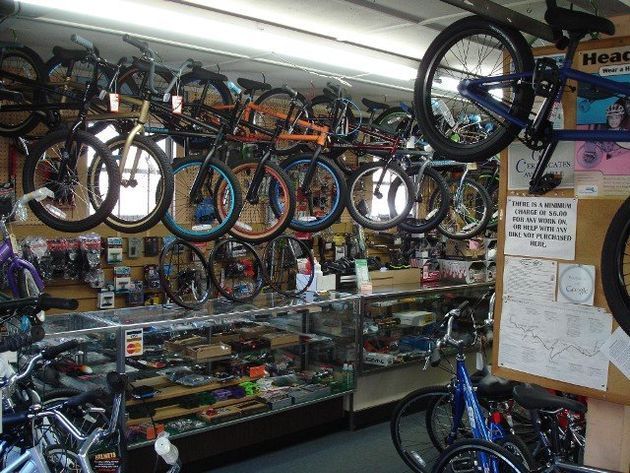 A bunch of bikes are hanging from the ceiling in a store