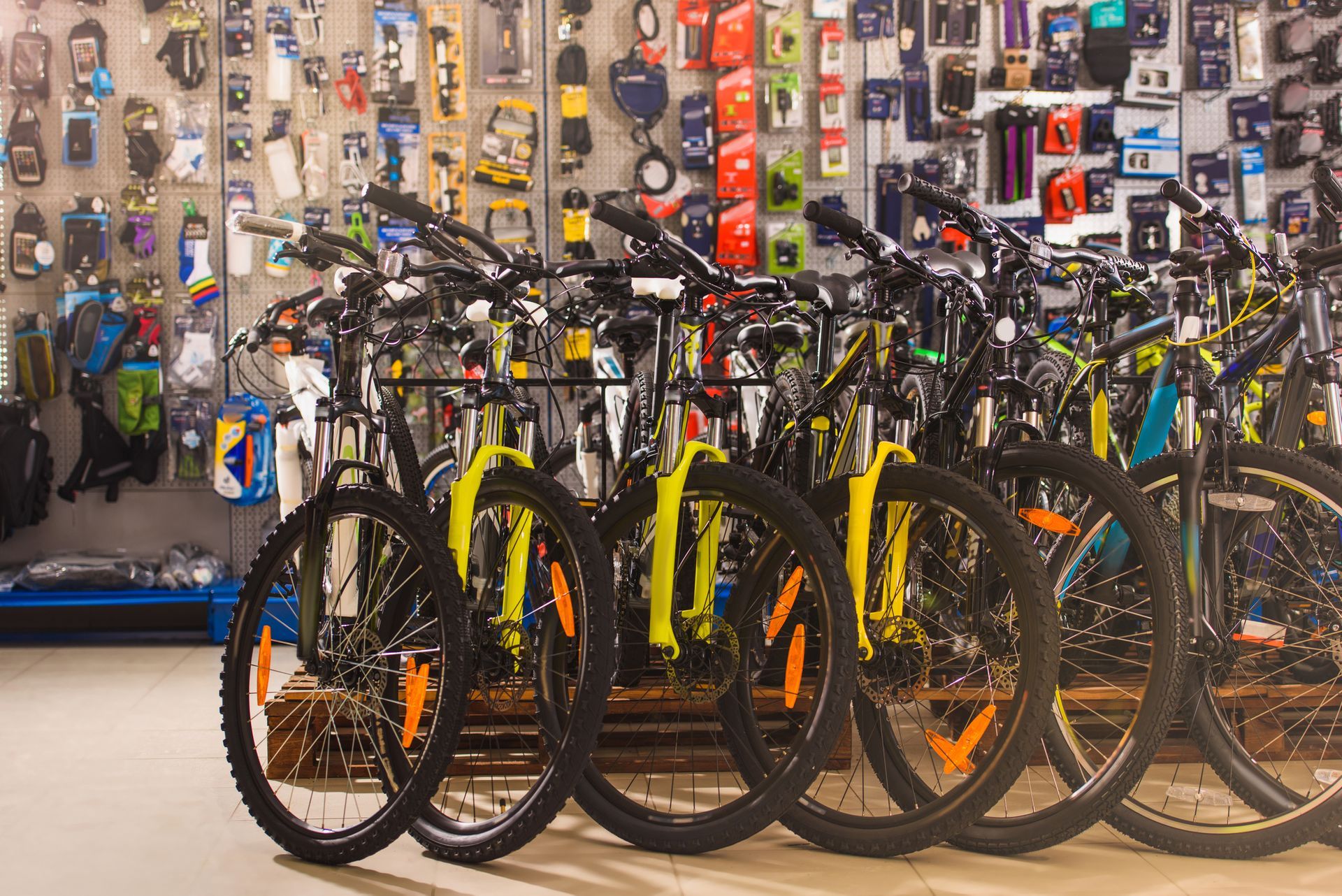 A row of bicycles are lined up in a bicycle shop.