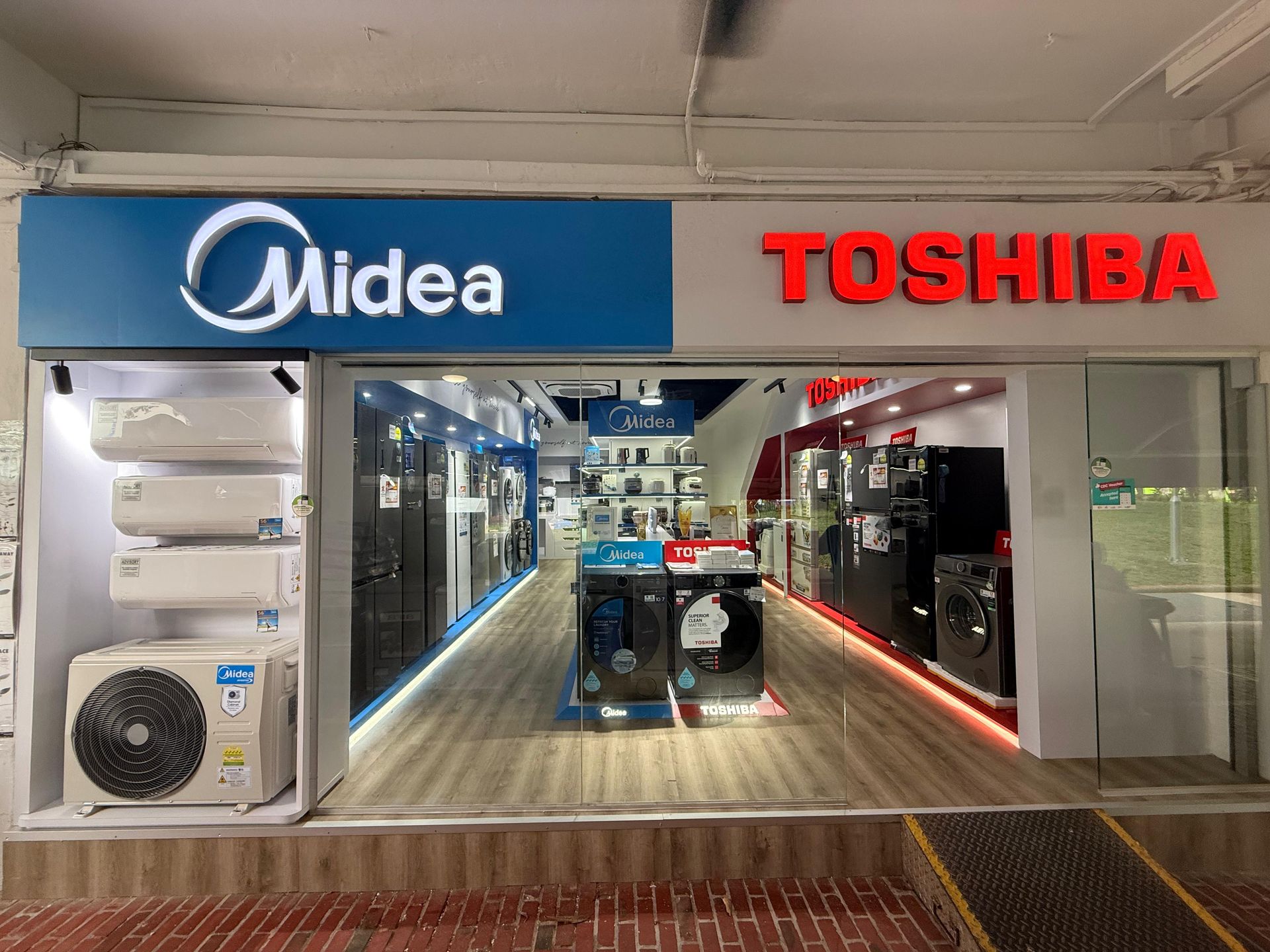 A midea and toshiba store with a lot of appliances on display.