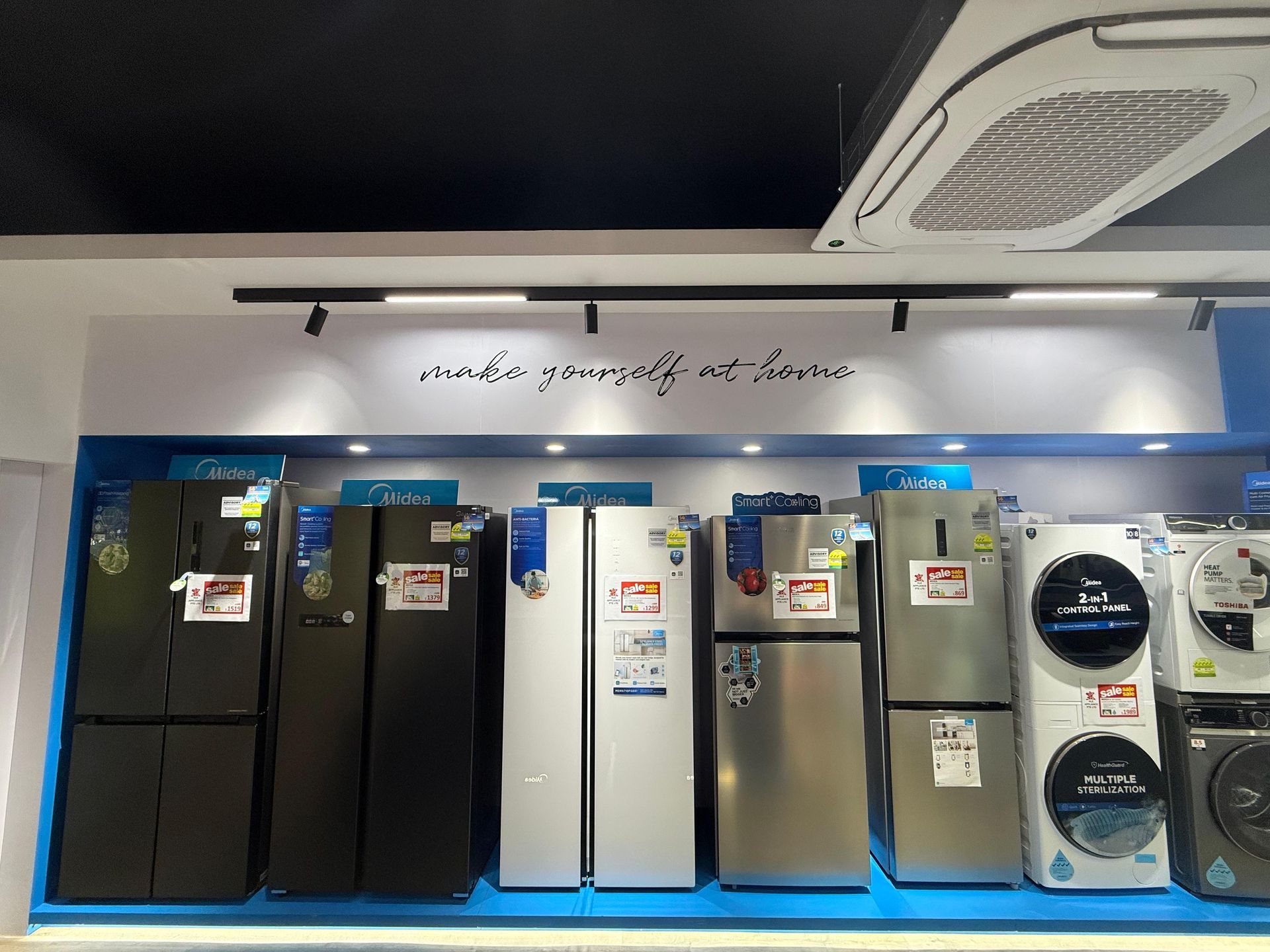 A display of refrigerators and washing machines in a store.