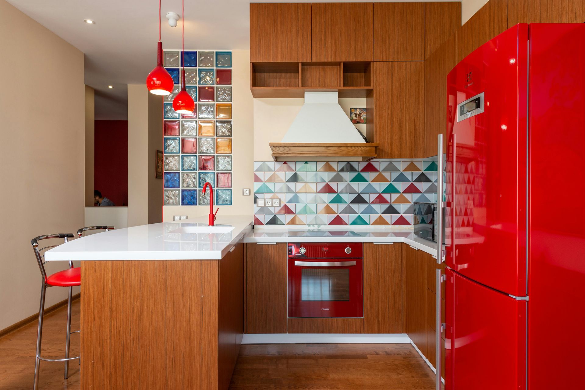 A kitchen with red appliances and a red refrigerator