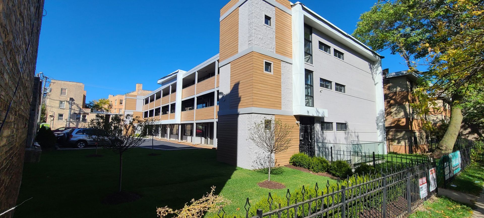 A large building with a wrought iron fence in front of it.