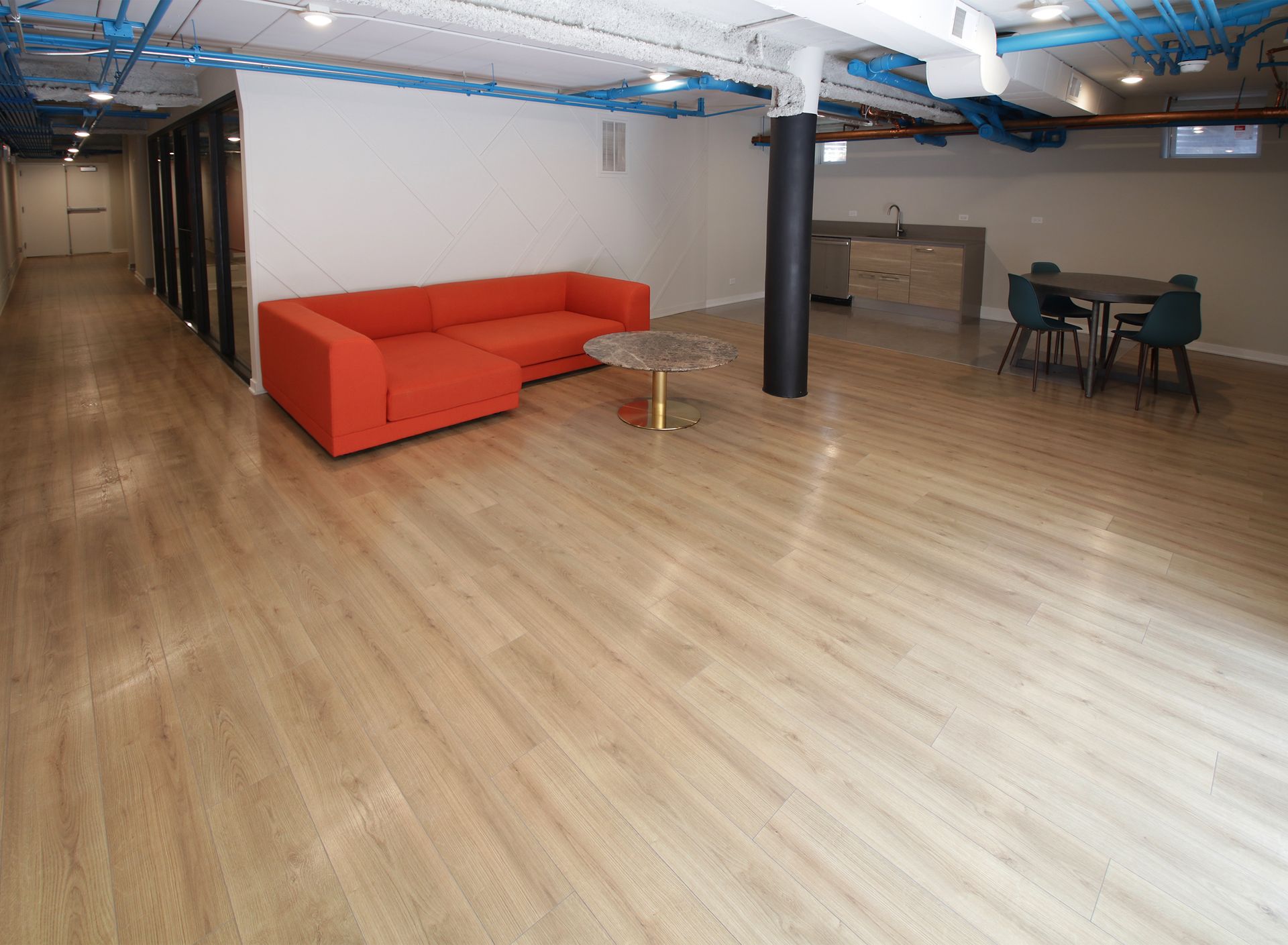 A living room with an orange couch and a table