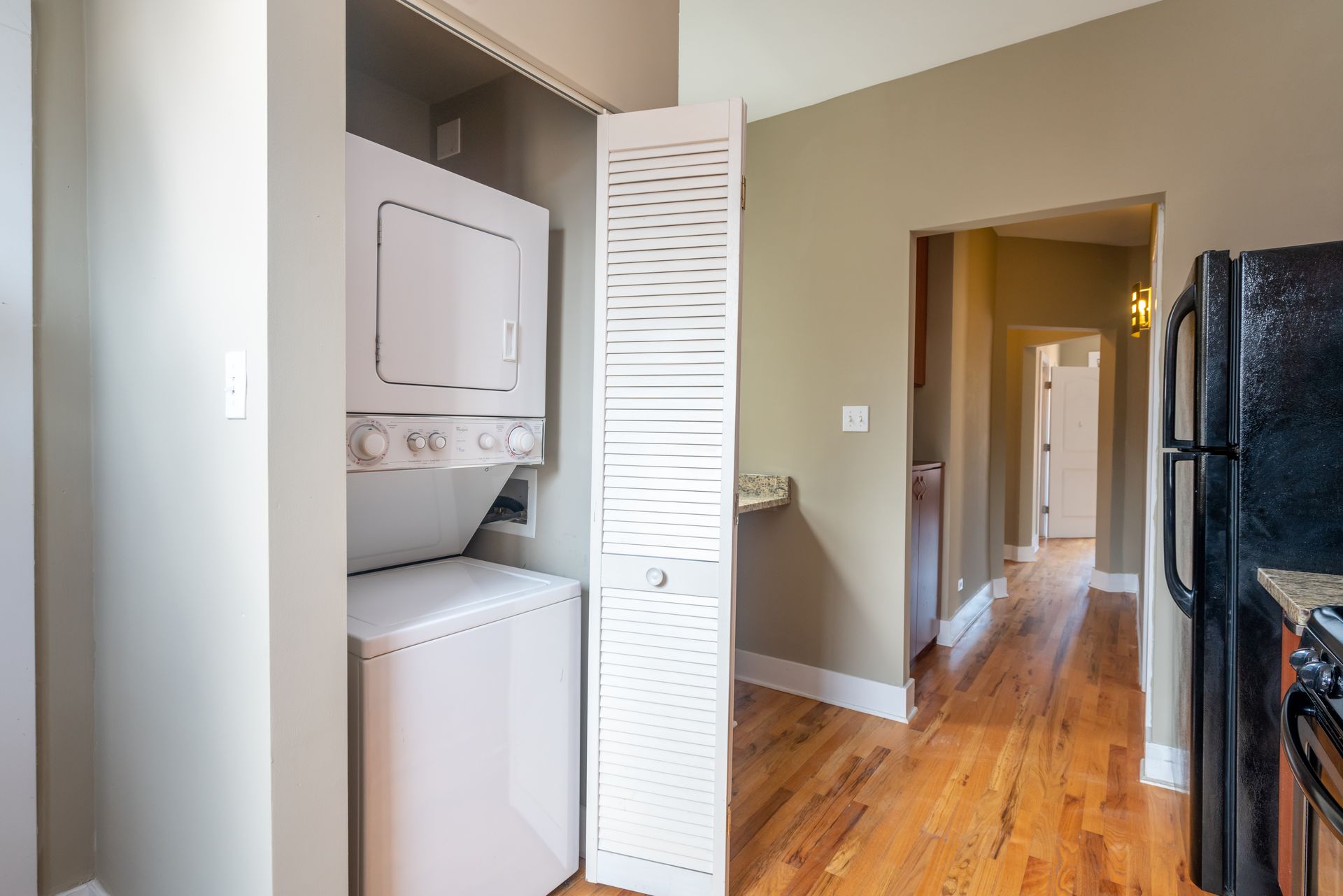 A washer and dryer are stacked on top of each other in a closet.