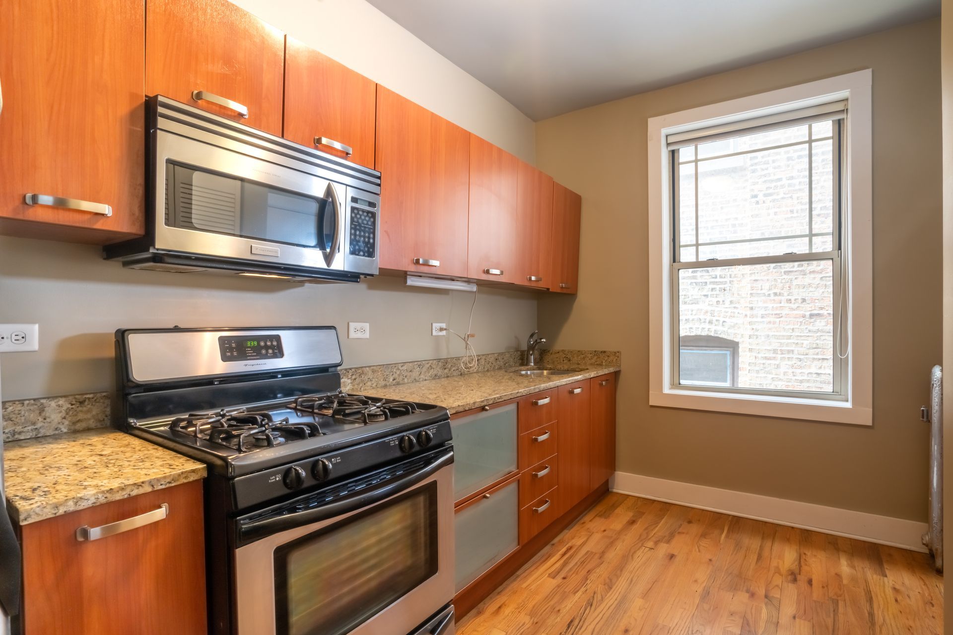 A kitchen with stainless steel appliances and wooden cabinets