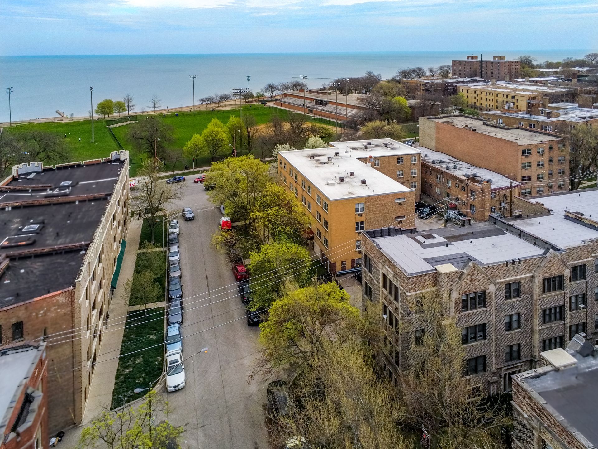 An aerial view of a city with a lot of buildings and a lake in the background.