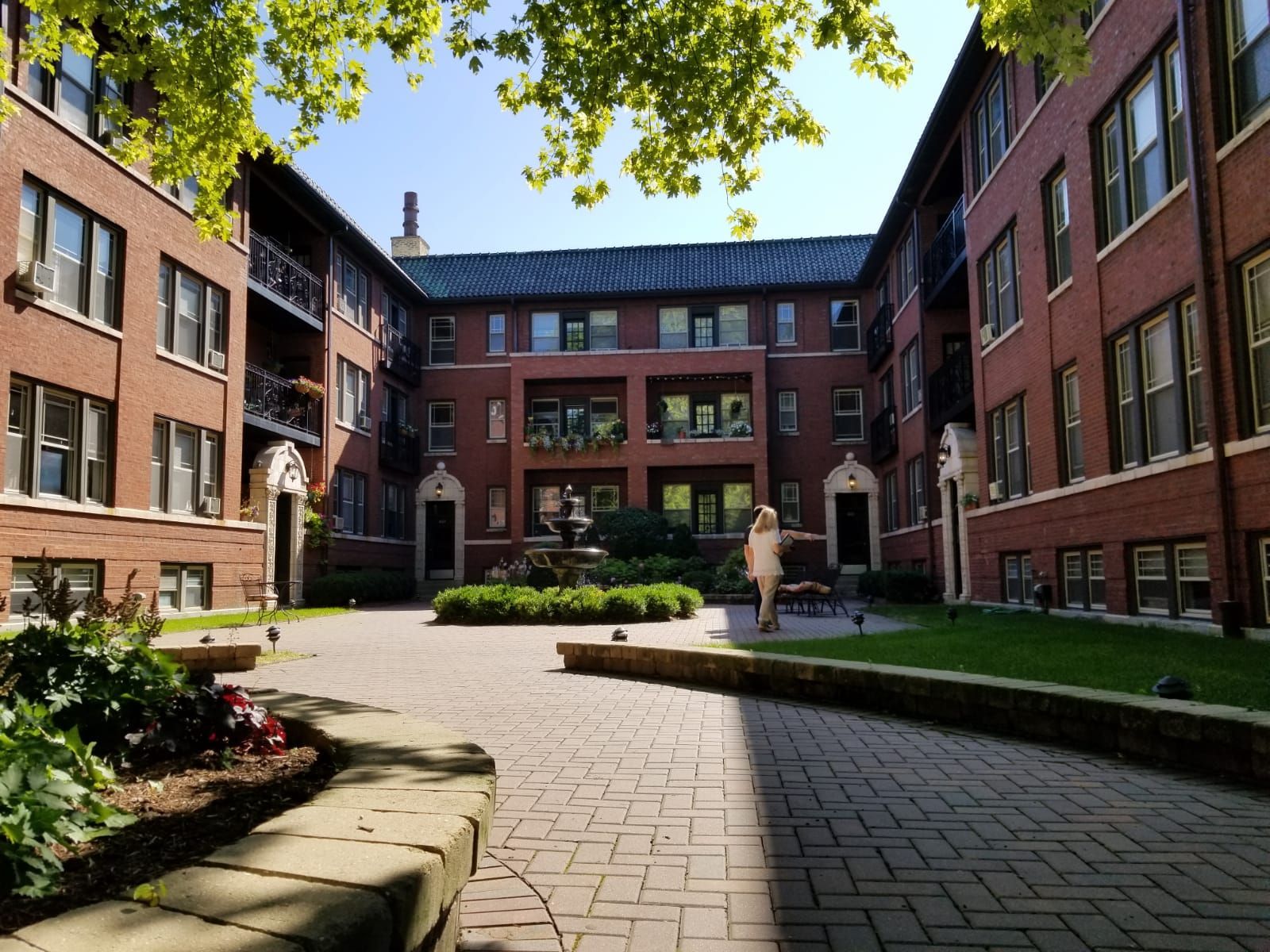 A brick building with a courtyard in front of it