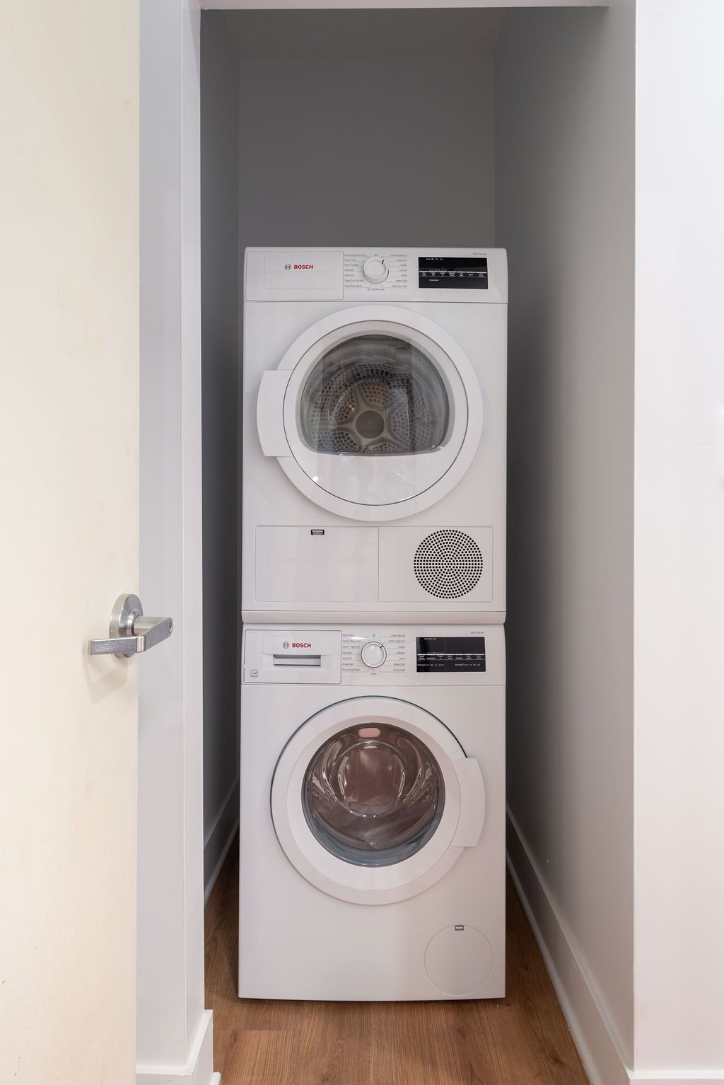 A washer and dryer are stacked on top of each other in a laundry room.