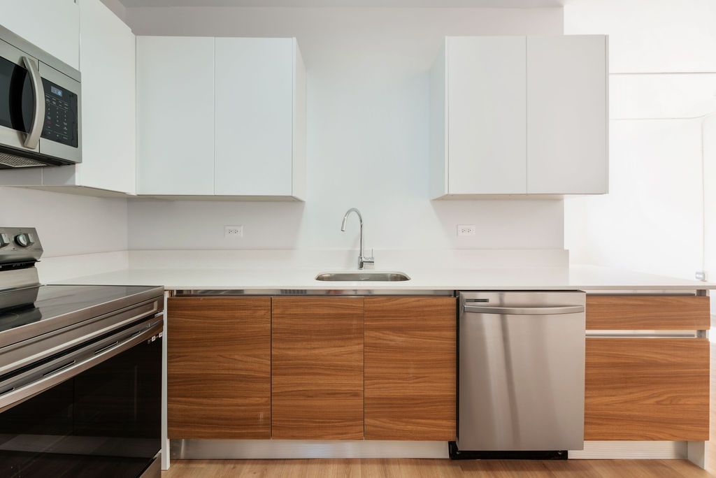 A kitchen with stainless steel appliances and wooden cabinets