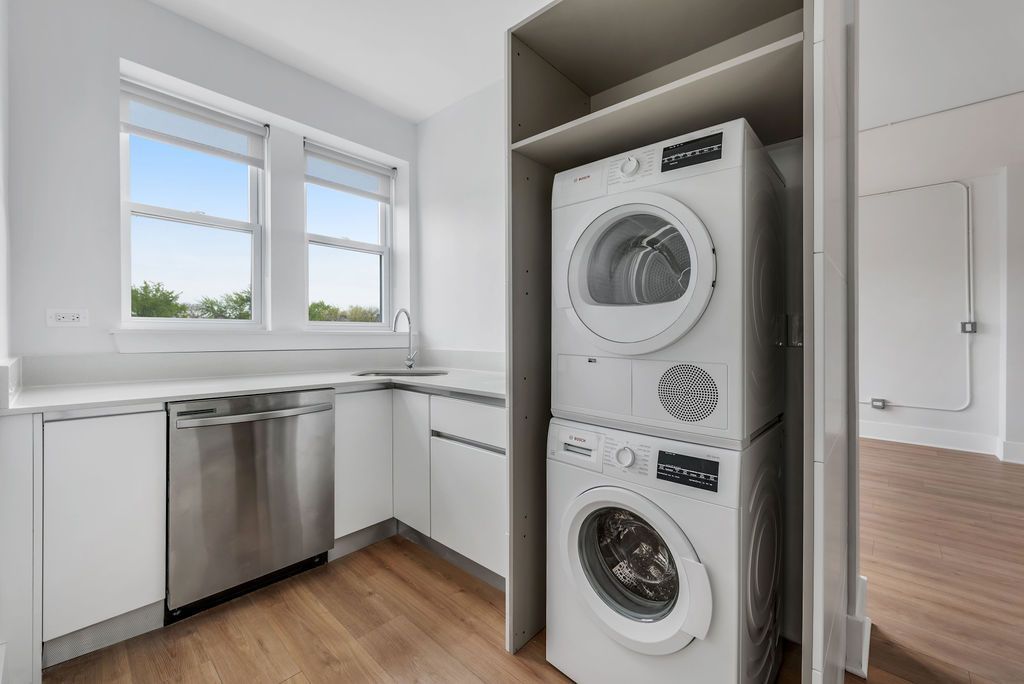 A laundry room with a washer and dryer stacked on top of each other.