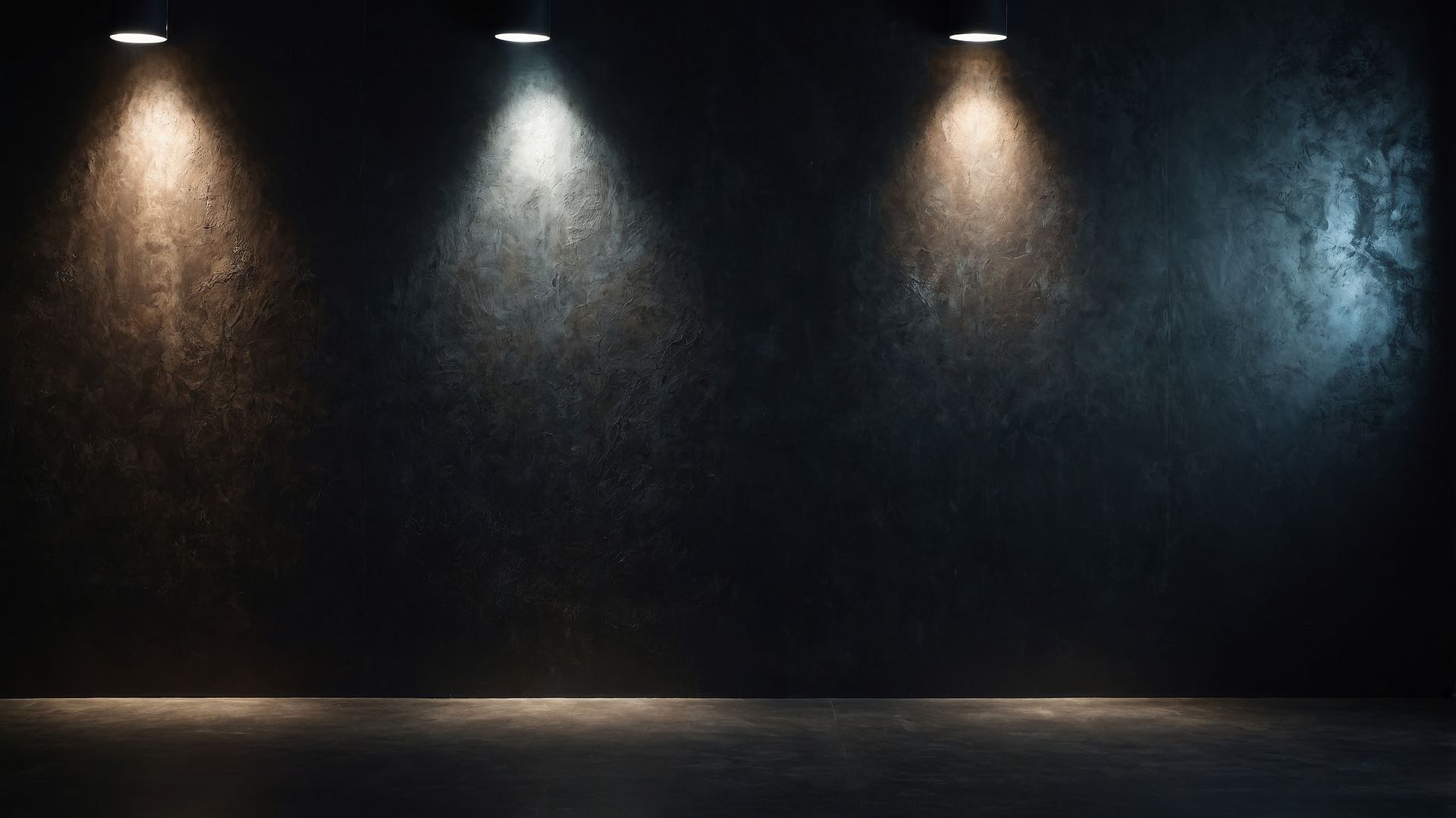 Modern kitchen with a black and gold island, stainless steel refrigerator, white cabinets, and gold accents.