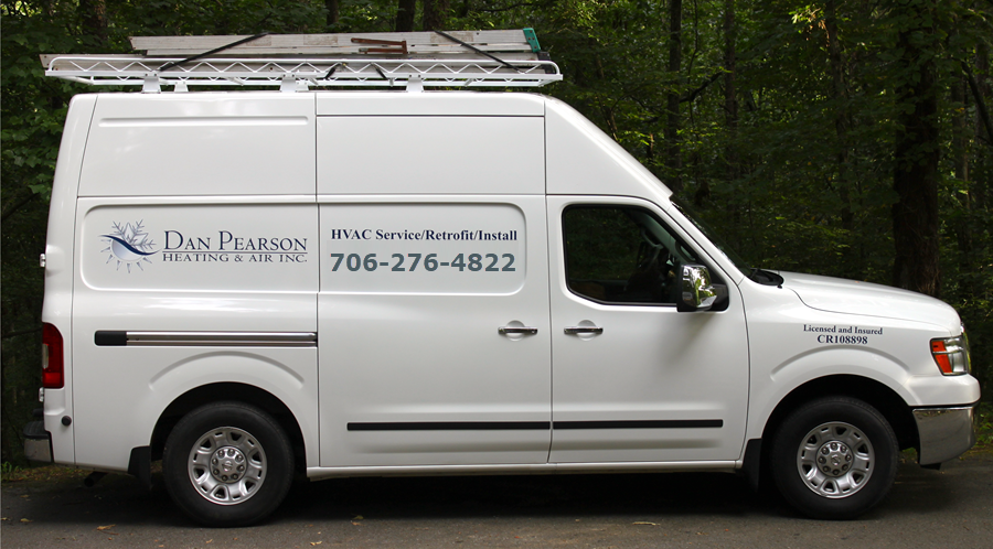 A white van with a Dan Pearson Heating & Air HVAC Services sign and phone number on the side