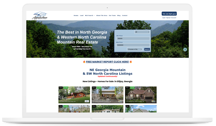 A laptop screen displays a website for homes for sale in North Georgia Mountains