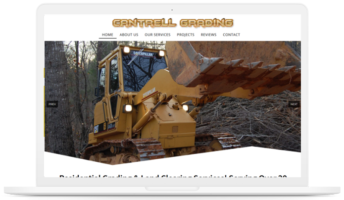 A computer screen shows a bulldozer on the control cardona website