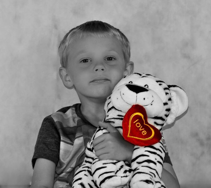 Photo of a child holding a soft toy