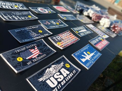 A table with a lot of stickers on it including one that says ' usa love it or leave it '