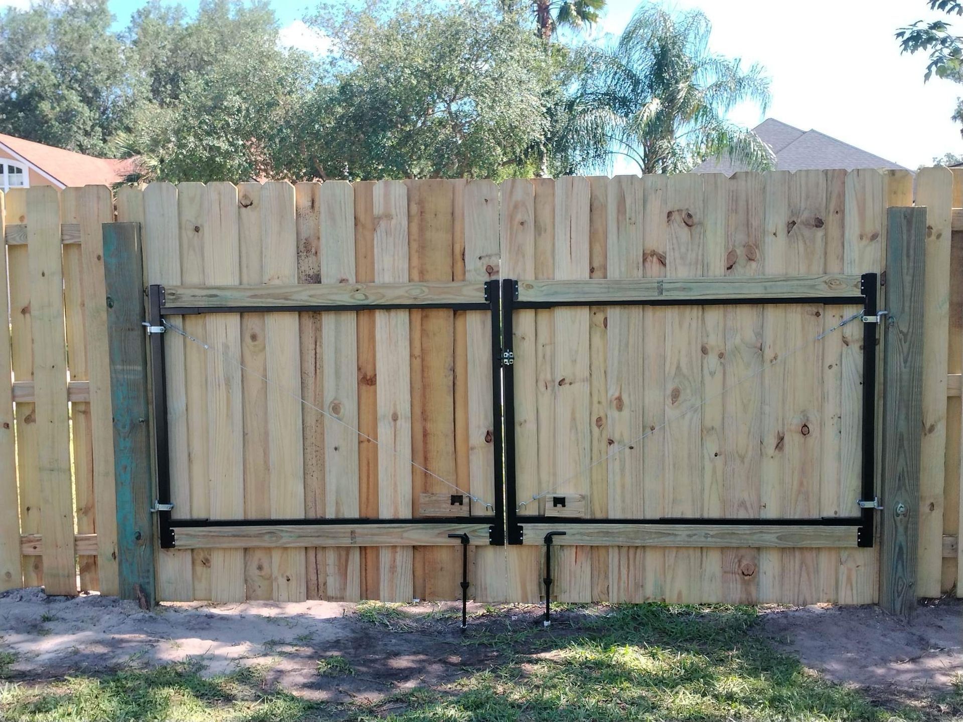 A wooden fence with a gate attached to it