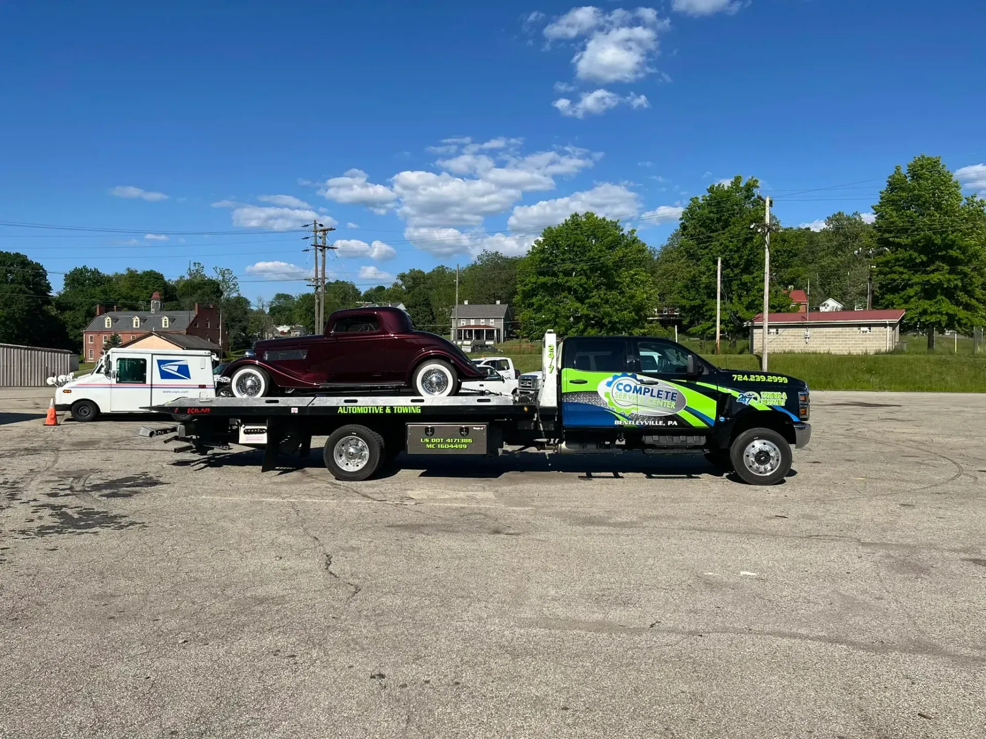 A Maroon Classic Car Loaded on a Tow Truck | Complete Service Center