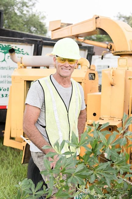 Man in Safety Vest in Goggles in Front of Tree Cutting Equipment — DeLand, FL — Treescapes Tree Removal Services
