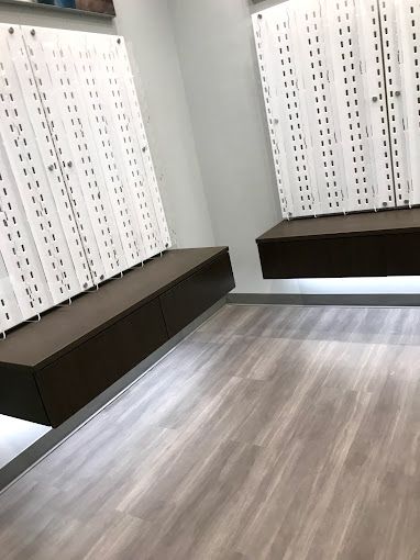 A room with a lot of lockers and a wooden floor.