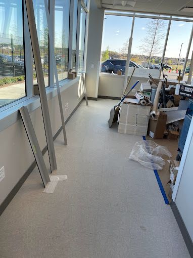 A room with a lot of windows and boxes on the floor.