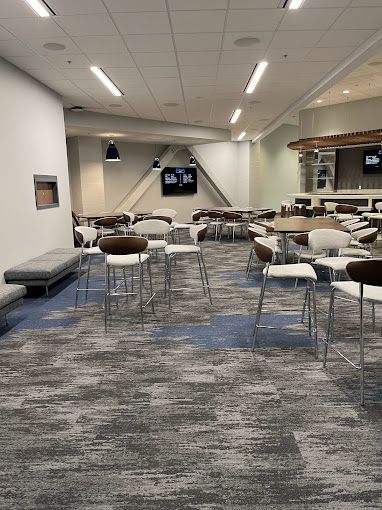 A large room with tables and chairs in it.