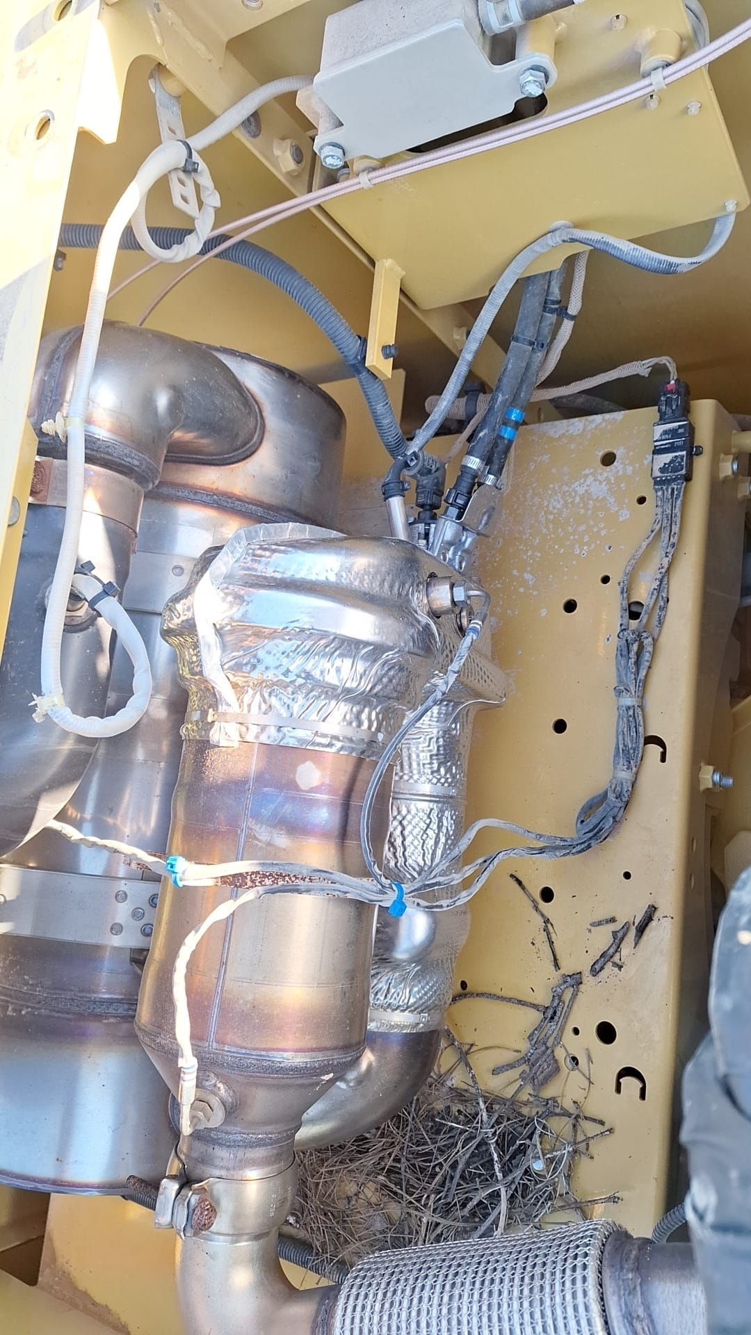 A close up of a catalytic converter on a vehicle.