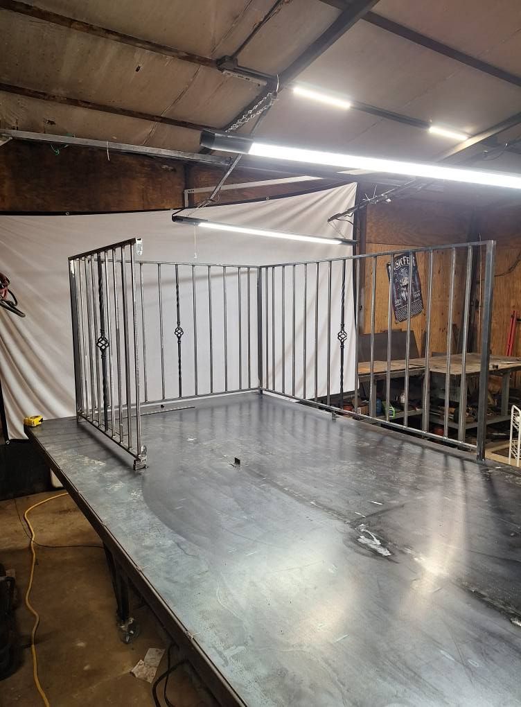 A metal fence is sitting on top of a metal table in a room.