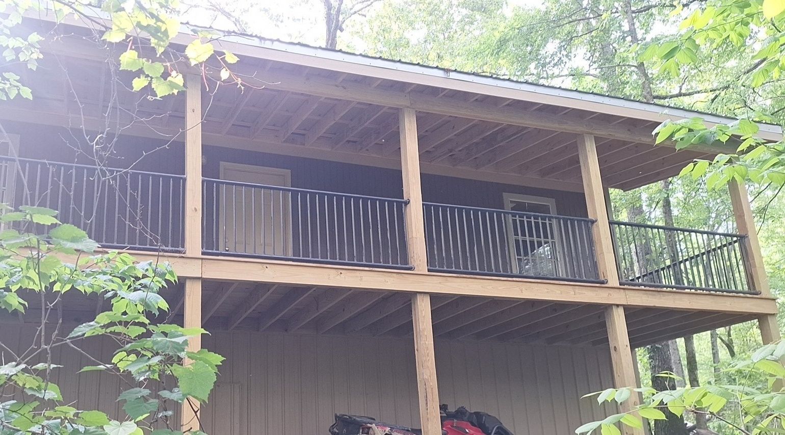 A wooden house with a balcony in the woods