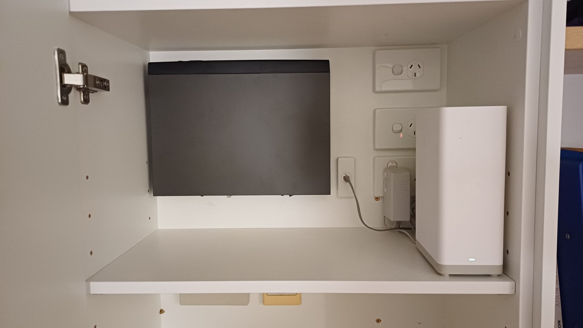 Empty White Cabinet Shelf With Wall Outlets — Green Valley Electrical in Ballina, NSW