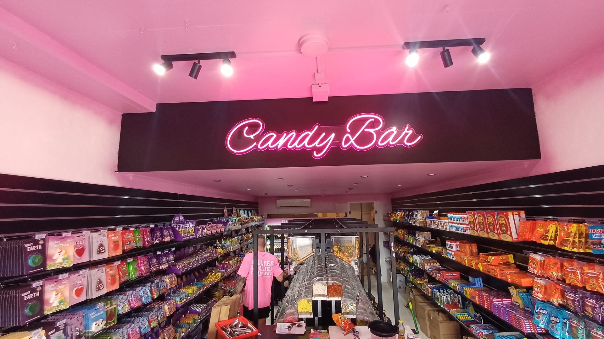 Pink Candy Shop Aisle With Neon “Candy Bar” Sign — Green Valley Electrical in Lismore, NSW