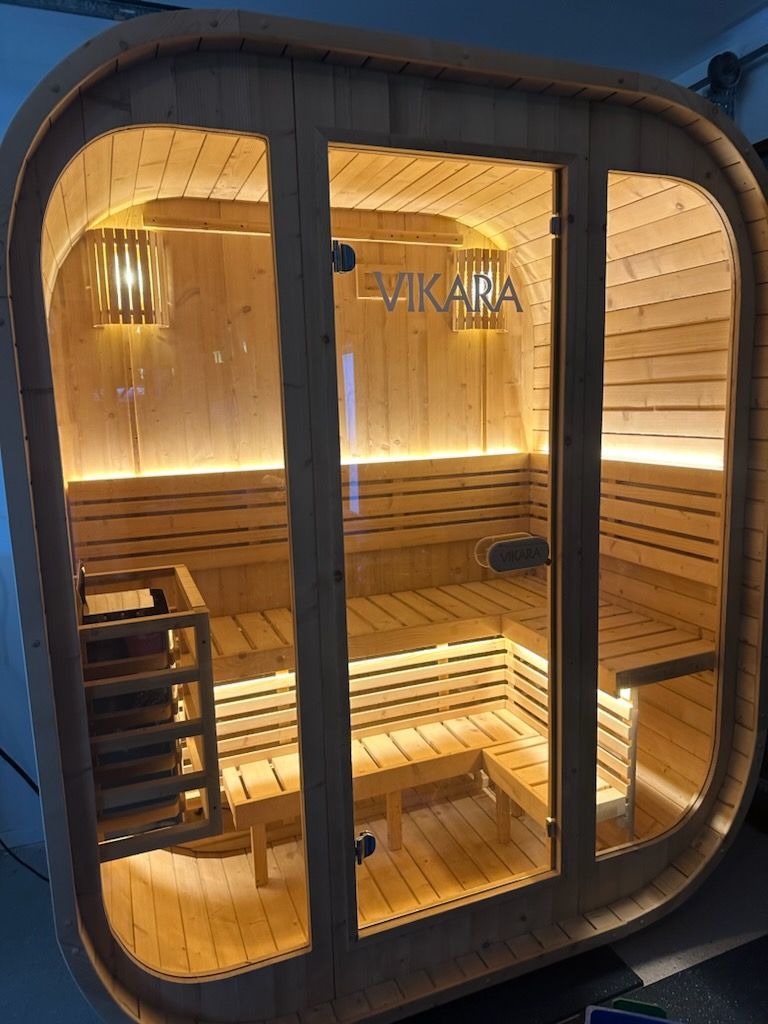Wood-Paneled Sauna Cabin With Warm Lighting — Green Valley Electrical in Ballina, NSW