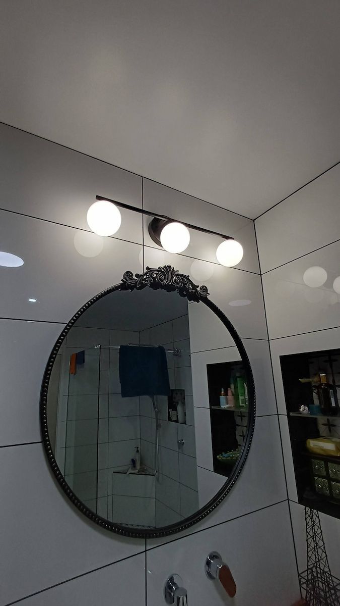 Round Wall Mirror Above a Sink with Three Bright Lights — Green Valley Electrical in Byron Bay, NSW