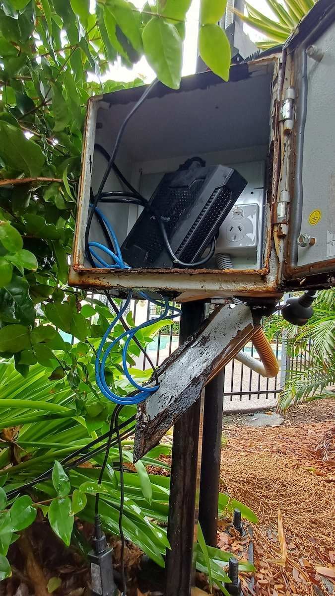 Open Utility Box With Exposed Wiring And Equipment Mounted On A Wooden — Green Valley Electrical in Byron Bay, NSW