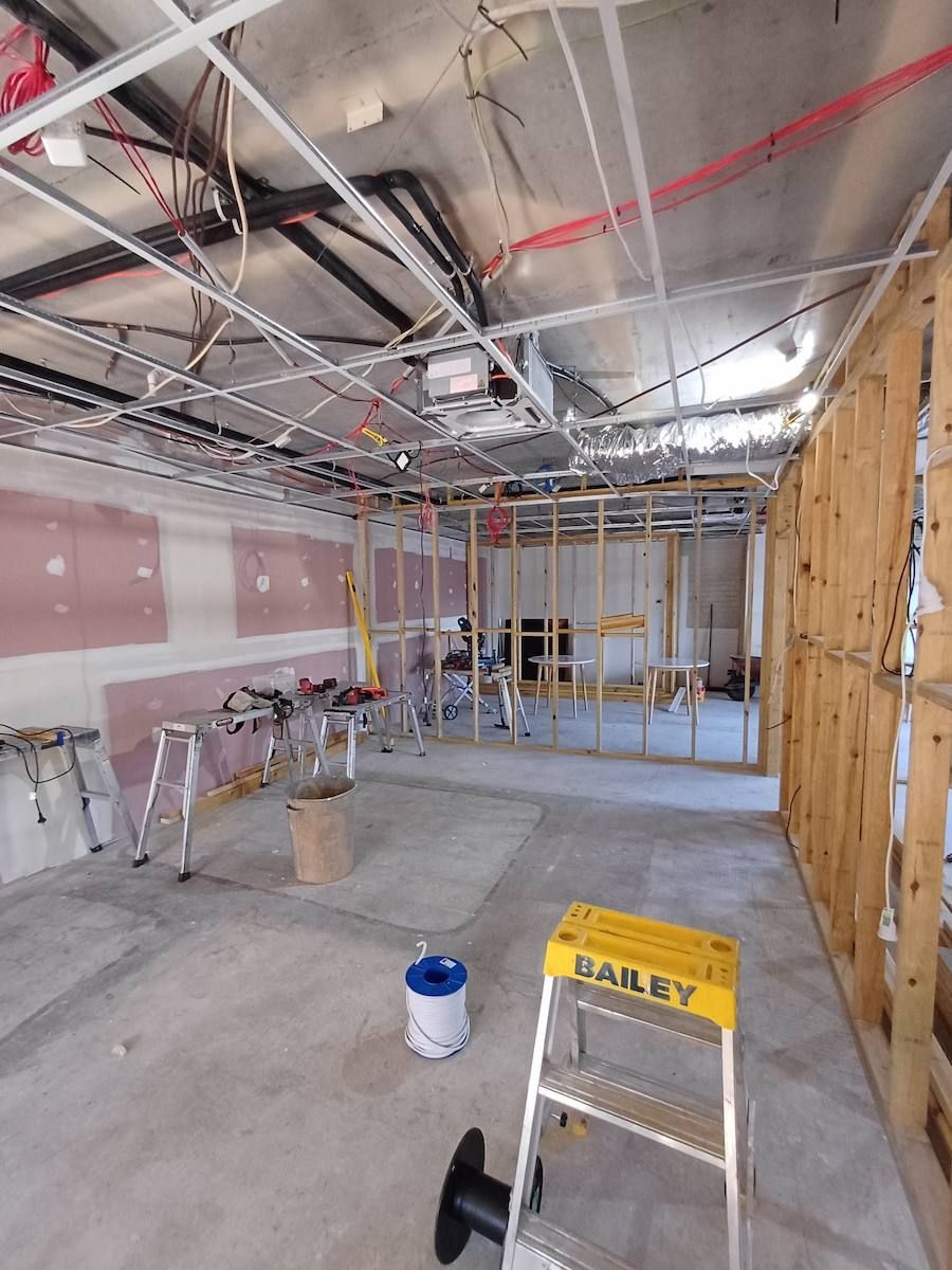 Unfinished Room with Exposed Ceiling Beams, Drywall, and A Ladder — Green Valley Electrical in Alstonville, NSW