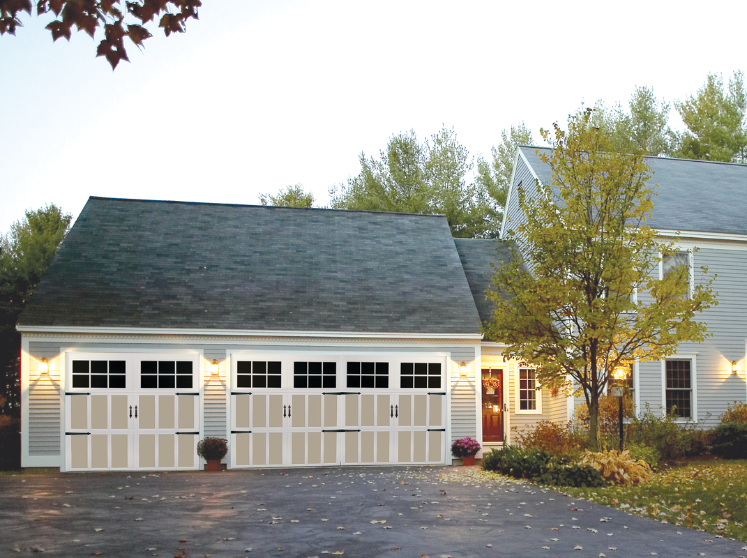 Two-car garage with beige doors, a gray roof, and a driveway leading up to it.