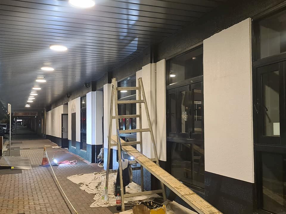 A Ladder is Sitting in Front of a Building Under Construction — BK Painting & Property Maintenance in Gracemere, QLD