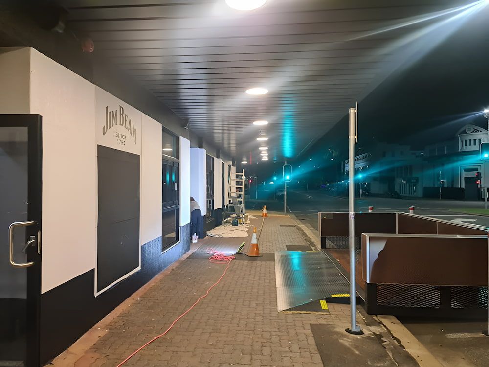 A Black and White Building With a Sign That Says Juice on It — BK Painting & Property Maintenance in Gracemere, QLD