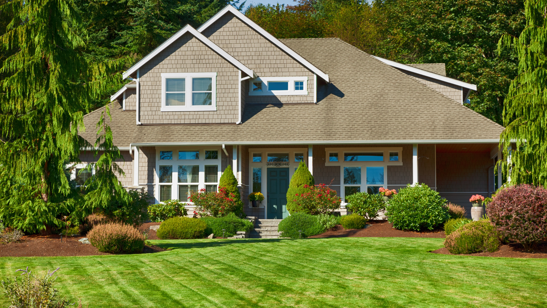 Electrician in a yellow hard hat working on electrical panel indoors.