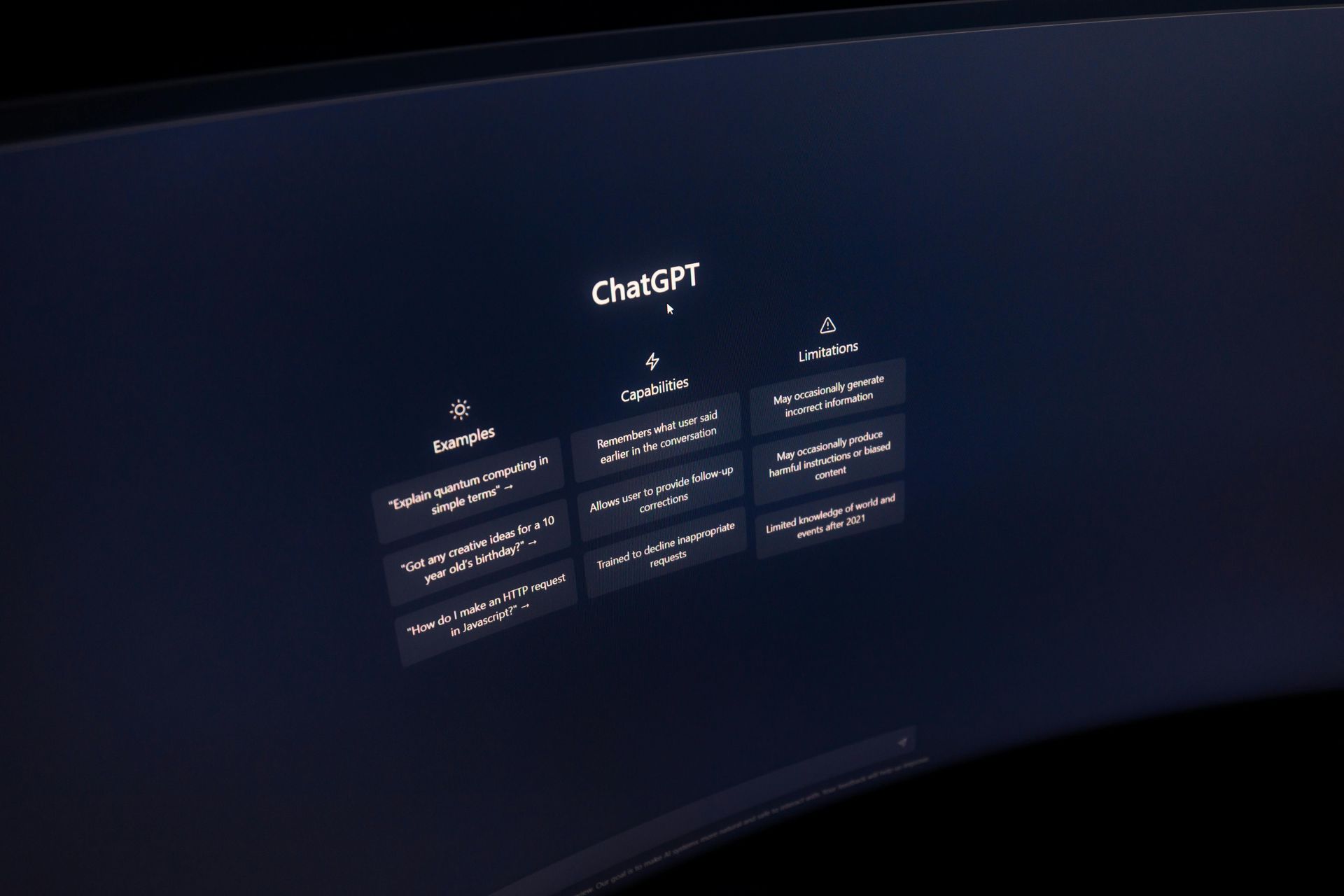 The ChatGPT welcome screen displays an interface with examples, capabilities, and limitations in white text on dark blue.