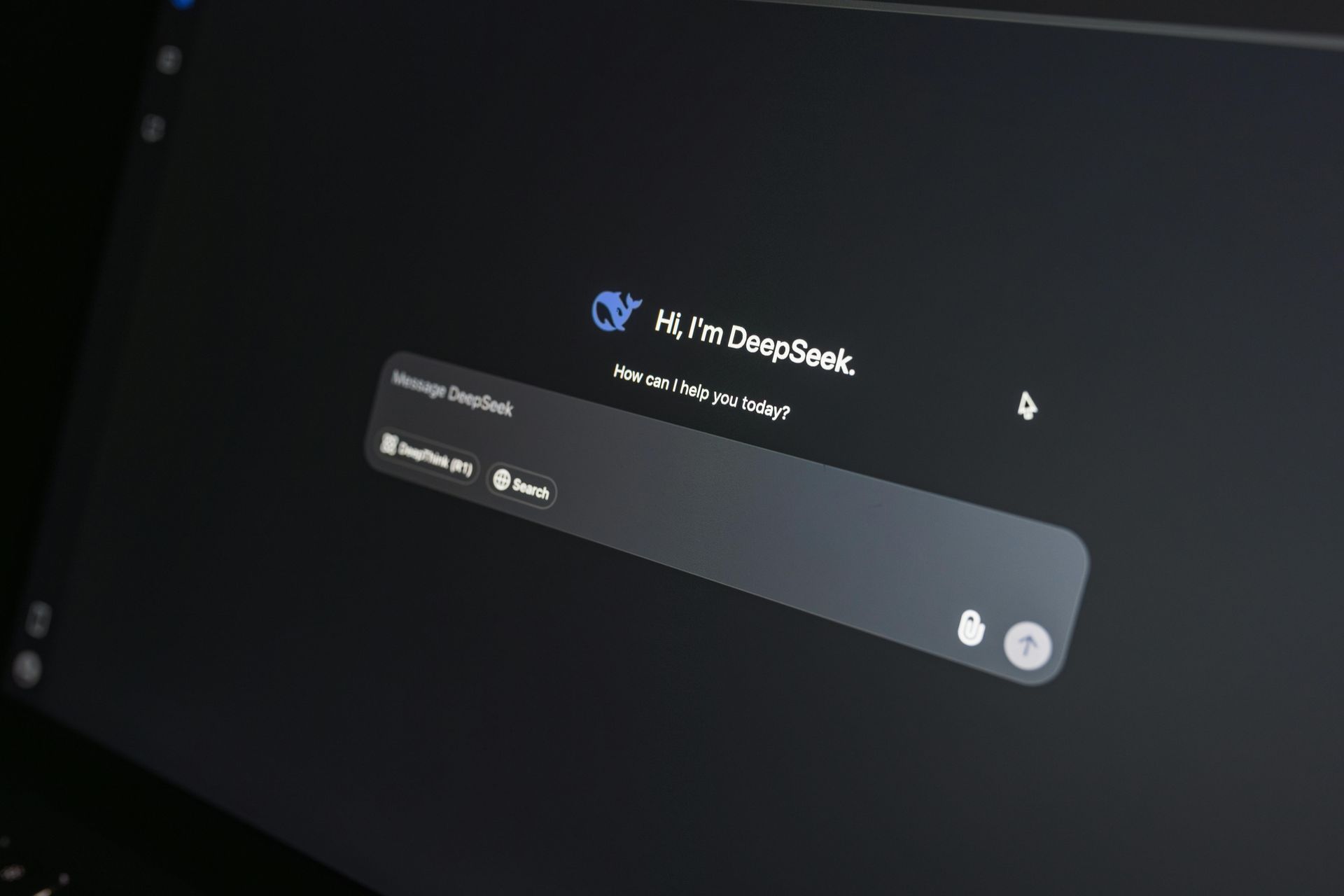 A dark-themed computer screen displaying the DeepSeek AI homepage with a centered chat input box.