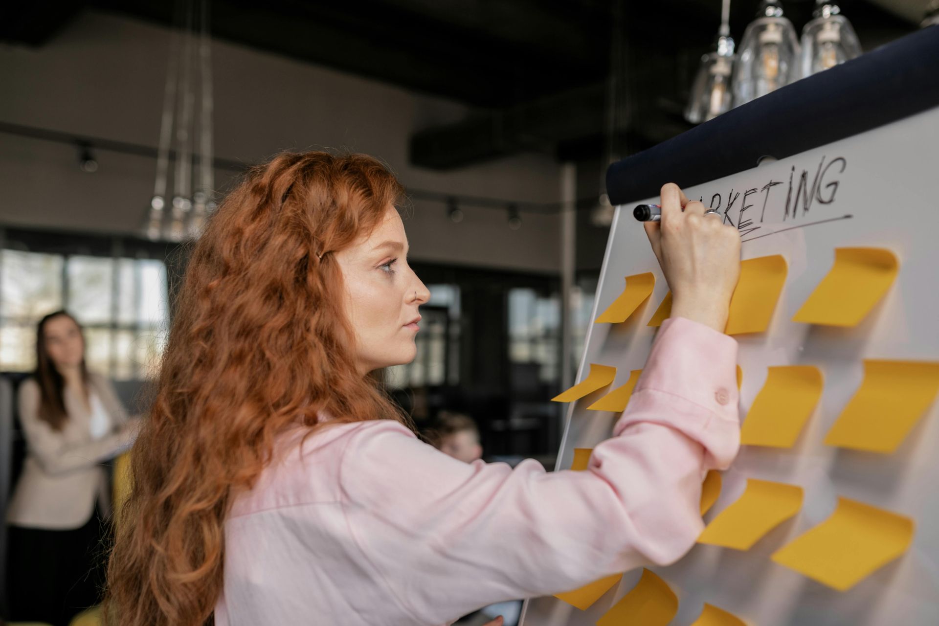 Woman with red hair writing
