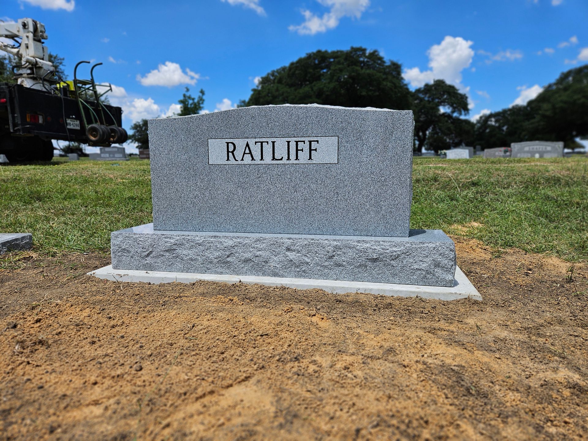 A gravestone in a cemetery with the name ratliff on it.