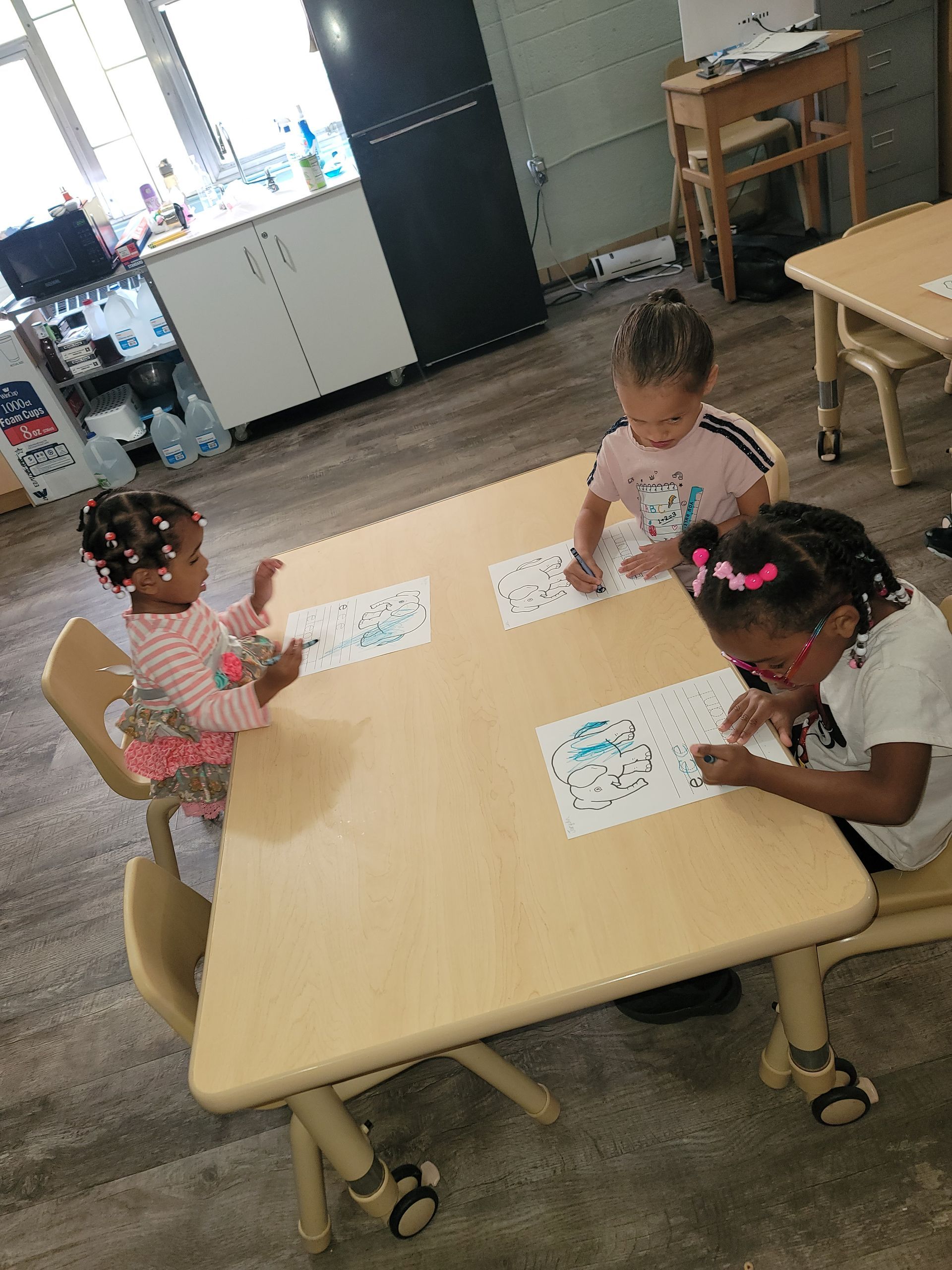 A Woman Is Standing in Front of A Group of Children