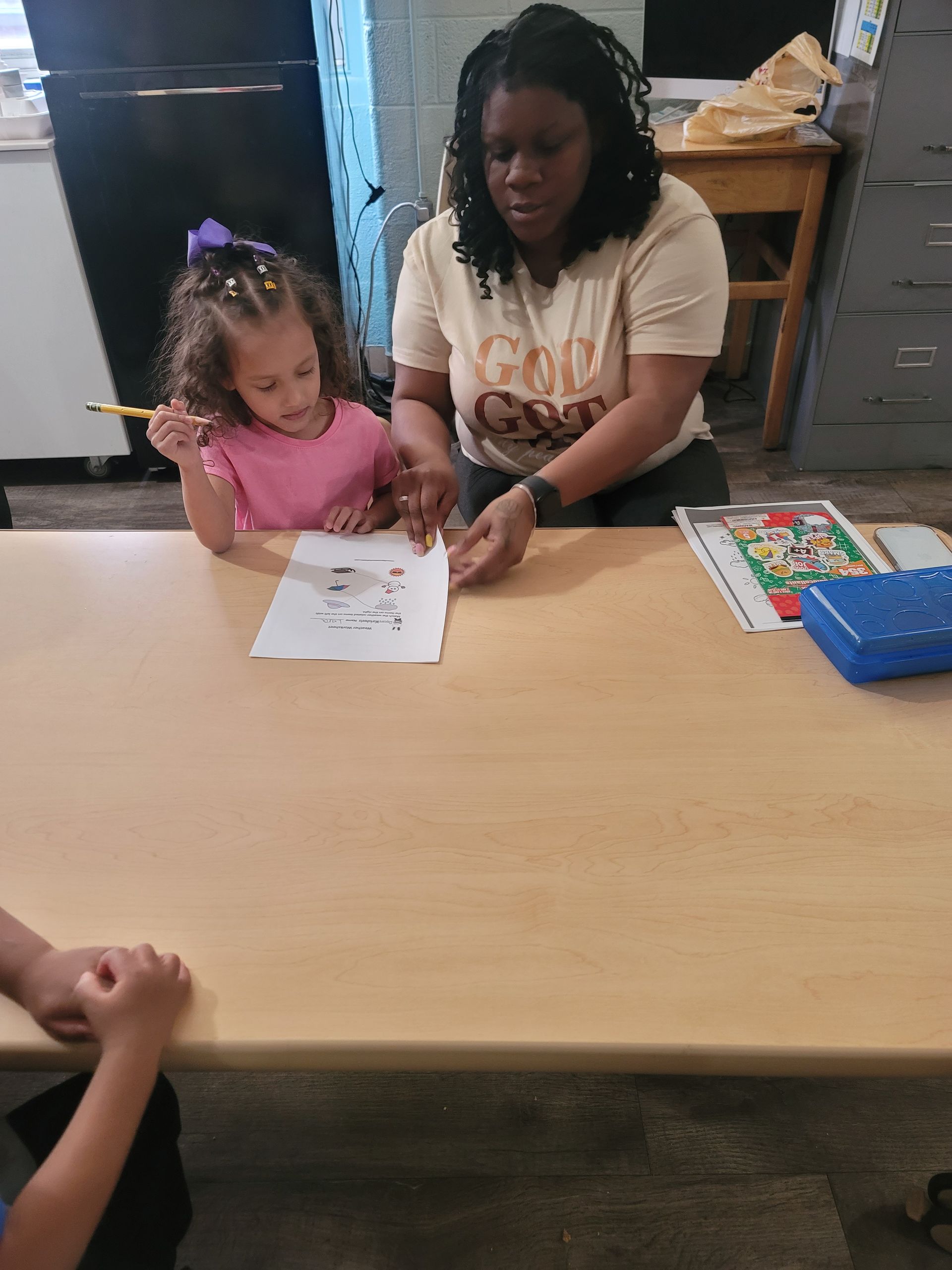 A Girl in A Minnie Mouse Shirt Is Standing in A Room with Other Children