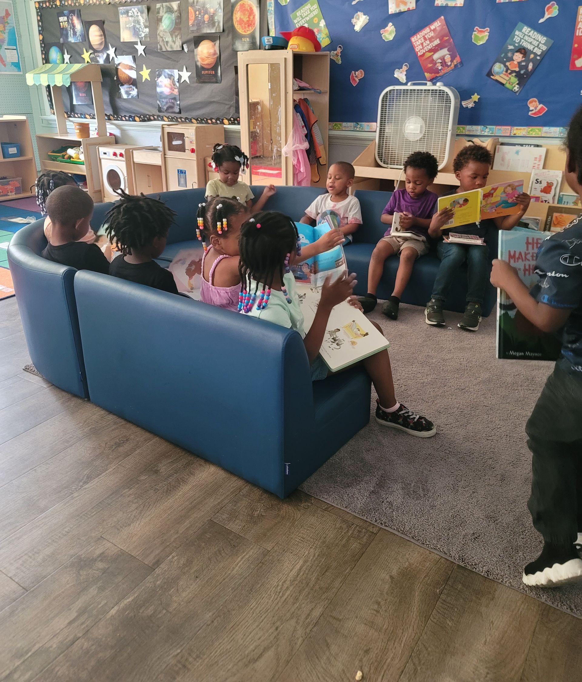 A Man in An Adidas Shirt Sits at A Table with Three Children