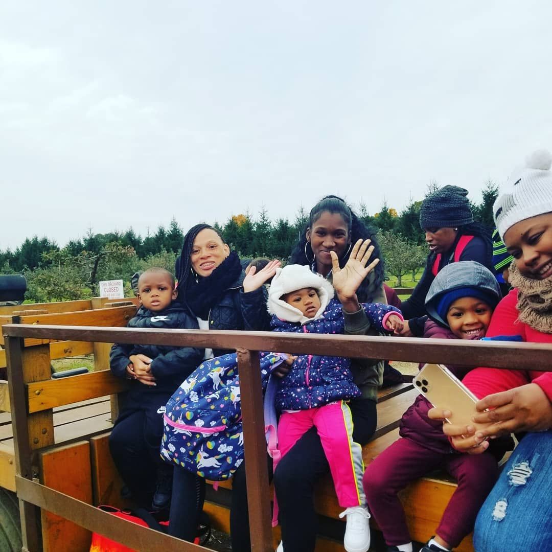 A Group of People Are Riding in The Back of A Truck