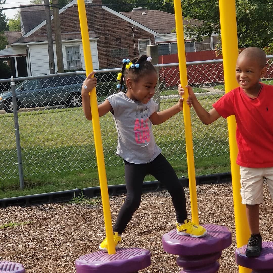 A Boy and A Girl Are Playing on A Swing Set